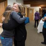 Chava Lee, President of the Congreation Sukkat Shalom Board, center, hugs Melissa Goldstein during a gathering at Temple Sukkat Shalom on Tuesday, Oct. 30, 2018, to honor the memory of the 11 people killed by a gunman at the Tree of Life synagogue in Pittsburgh, Pennsylvania, on Saturday. (Michael Penn | Juneau Empire)