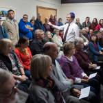 Congregation Sukkat Shalom member Jesse Kiehl makes his way through an overflowing audience asking for names of people to be remembered at Temple Sukkat Shalom on Tuesday, Oct. 30, 2018. The gathering at Temple Sukkat Shalom honored the memory of the 11 people killed by a gunman at the Tree of Life synagogue in Pittsburgh, Pennsylvania, on Saturday. (Michael Penn | Juneau Empire)
