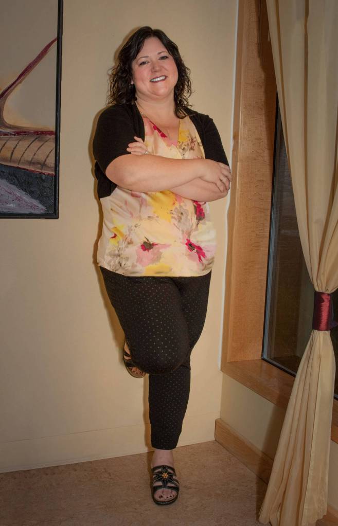 Nov. 18, 2018: On a dark and gray Friday in November, Nanci Chisholm was a definite bright spot! On her feet all day at work, she knows how to dress for both comfort and style. This day she wore Black Pixie ankle pants from Old Navy, an Ann Taylor multi-color empire waist blouse, a black shrug from The Dress Barn, and Clarks wedge sandals, which she says are comfortable inside year round.