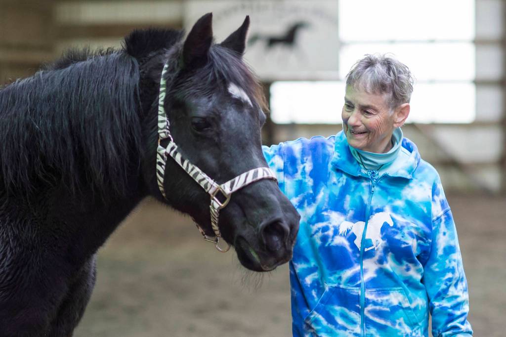 Dr. Susan Hunter-Joerns spends time with her 20-year-old Arabian stallion, Dante, at the Fairweather Equestrian Center on Monday, Nov. 19, 2018. (Michael Penn | Juneau Empire)