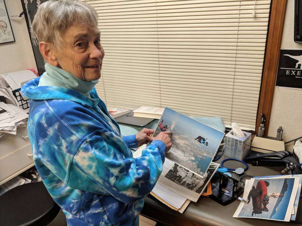 Dr. Susan Hunter-Joerns shows off a recent photo of her skydiving. After Hunter-Joerns ex-husband, Jack Joerns, passed away, Joerns spread his ashes in the air near a house he built on what would have been Joerns 92nd birthday. (Ben Hohenstatt | Capital City Weekly)