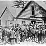 This is the only known photograph we have of the interior of Skagways First City Hall during its time period as the towns city hall. George A. Brackett with his long beard is seated on the immediate right. Brackett was the builder of the Brackett Wagon Road that ran from Skagway to White Pass City. Based on the presence of Brackett, it is possible that this picture represents the start or finish of negotiations between Brackett and the White Pass & Yukon Route railroad over the purchase of the Brackett Wagon Road by the railroad. (National Park Service, Klondike Gold Rush National Historical Park, Brackett Family Collection, BFC/CBD 156; KLGO PB-38-6237)