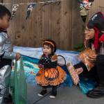 Dr. Kim Hort, Pediatric Dentist Manager for the SouthEast Alaska Regional Health Consortiums Childrens Dental Clinic, hands out candy and toothbrushes to Jared Lumba, 4, and his sister, Sue, 1, on Front Street on Wednesday, Oct. 31, 2018. For the fourth year Kindred Post has organized the Halloween celebration for trick-or-treaters. (Michael Penn | Juneau Empire)