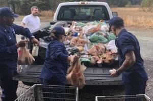 U.S. Coast Guard Station Juneau personnel unload a truck with canned goods that were donated for the Coast Guards annual Haunted Station. (Courtesy Photo | Southeast Alaska Food Bank)