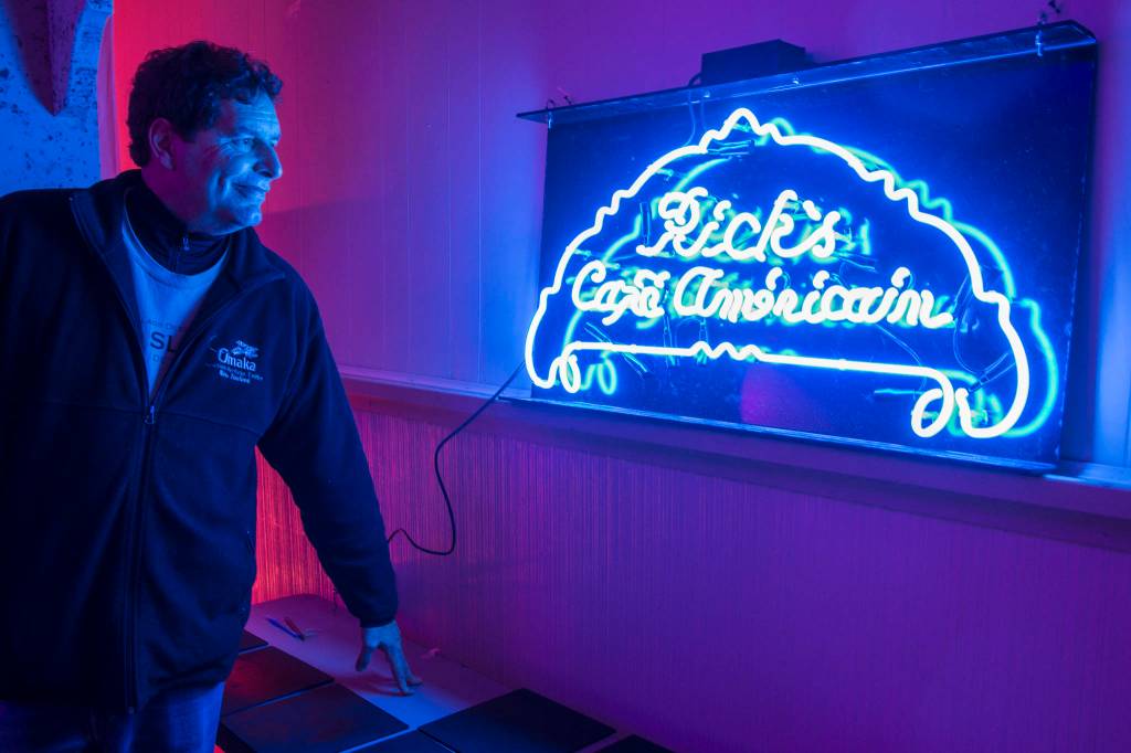 Juneau Lyric Opera boardmember John Clough admires their Ricks Cafe Americain neon sign as they transform the Rockwell Ballroom to a 1941 Moroccian cafe for Heres Looking at You, Casablanca on Monday, Nov. 5, 2018. The show is a presentation by the Juneau Lyric Opera and Gold Town Nickelodeon. (Michael Penn | Juneau Empire)