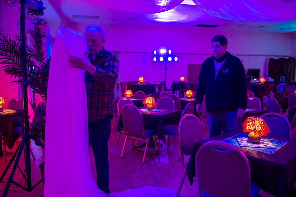 Juneau Lyric Opera boardmember John Clough, right, watches as set designer Nathan Rodda creates Ricks Cafe Americain at the Rockwell Ballroom for Heres Looking at You, Casablanca on Monday, Nov. 5, 2018. The show is a presentation by the Juneau Lyric Opera and Gold Town Nickelodeon. (Michael Penn | Juneau Empire)