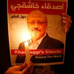 Activists, protesting the killing of Saudi journalist Jamal Khashoggi, hold a candlelight vigil outside Saudi Arabias consulate in Istanbul, Thursday, Oct. 25, 2018. The poster reads in Arabic: Khashoggis Friends Around the World. A group of Arab and international public, political and media figures are establishing a global association called Khashoggis Friends Around the World; to achieve justice for the freedom martyr.(AP Photo/Lefteris Pitarakis)