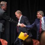 Former state Senator Mike Dunleavy, left, Gov. Bill Walker, center, and former U.S. Senator Mark Begich shake hands after a debate at a Juneau Chamber of Commerce luncheon at Centennial Hall on Thursday, Sept. 6, 2018. (Michael Penn | Juneau Empire)