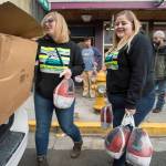 Cassandra Strahin, left, and Nicole Huntsman, of Allen Marine, deliver 30 frozen turkeys to the Glory Hole on Monday, Nov. 6, 2017. (Michael Penn | Juneau Empire File)