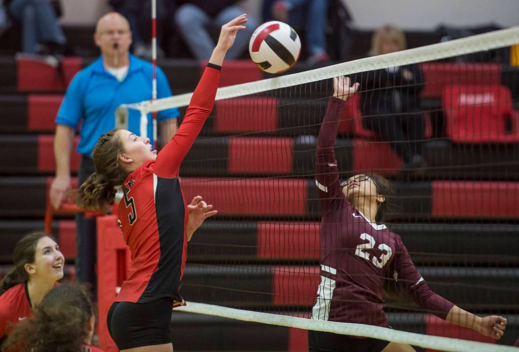 Juneau-Douglas JoJo Griggs puts the ball away against Ketchikans Karen Abigania in the first round of the Region V Volleyball Championships at JDHS on Friday, Nov. 2, 2018. JDHS won 3-0 (25-13, 25-16, 25-16). (Michael Penn | Juneau Empire)
