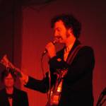 George C. Kuhar takes a break from propulsive guitar boogie to read from a letter written to his late father during the annual Skull Party held Friday evening at the Rockwell Ballroom. Ben Hohenstatt | Capital City Weekly)