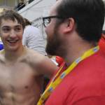 Juneau-Douglas High School senior Tyler Weldon speaks with coach Seth Cayce following his third-place finish in the 50-yard freestyle on Saturday at the ASAA/First National Bank Alaska Swim & Dive Championships at Bartlett Pool in Anchorage. The second through eighth-place finishers all finished within 0.51 seconds of one another. (Michael Dinneen | For the Juneau Empire)