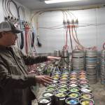 Alaskan Brewing Co.s Andy Kline shows off a new walk-in refrigerator the brewery is using for its new taproom, which opened Saturday. (Kevin Gullufsen | Juneau Empire)