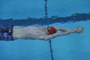 Juneau-Douglas High School sophomore Caleb Peimann prepares to surface in the 100-yard backstroke at the ASAA/First National Bank Alaska State Swim and Dive Championships on Saturday, Nov. 3, 2018. Peimann finished eighth with a time of 56.35 seconds (Michael Dinneen | For the Juneau Empire)