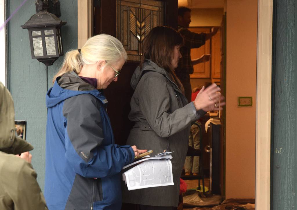 Alyse Galvin, Alaskas independent candidate for U.S. House of Representatives, talks to a woman named Amanda (not pictured) while going door to door for support Sunday, Nov. 4, 2018 in the Mendenhall Valley. Galvin was in Juneau for a final campaign stop ahead of the election. (James Brooks | Juneau Empire)