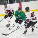 Colony High School sophomore Kaden Ketchum skates between Juneau-Douglas senior Cameron Smith, left, and junior Ethan Welch during the Palmer Showdown Tournament on Thursday at the MTA Events Center in Palmer. The Knights won 3-1. JDHS plays reigning Division I state champion Dimond on Friday. (Nolin Ainsworth | Juneau Empire)