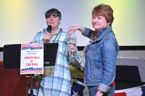 League of Women Voters of Juneau Director Judith Mitchell and Vice President Marianne Mills draw a door prize during the Leagues fourth annual Wine Tasting and Silent Auction Fundraiser on Oct. 5, 2018, at the Hangar Ballroom. (Courtesy Photo | Kim Andree Jones)
