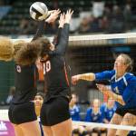 Thunder Mountain High School sophomore Sophia Harvey spikes the ball in between West Anchorages Danika Brown, left, and Kathleen Dexter in the first round of the ASAA/First National Bank Alaska 3A/4A Volleyball State Championships on Thursday at the Alaska Airlines Center in Anchorage. (Nolin Ainsworth | Juneau Empire)