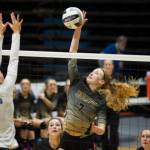South Anchorage High School sophomore Kinsey Schilke spikes the ball as Thunder Mountains Lily Smith goes up for the block at the ASAA/First National Bank Alaska 3A/4A Volleyball State Championships on Friday at the Alaska Airlines Center in Anchorage. South won 3-0 (25-10, 25-21, 25-12). (Nolin Ainsworth | Juneau Empire)