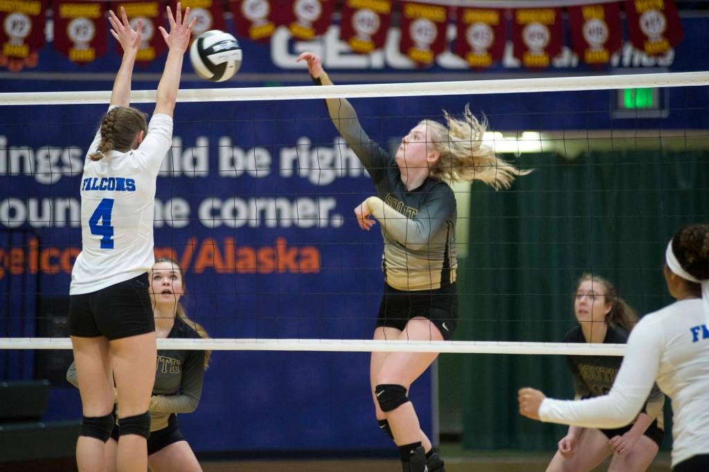 South Anchorage High School senior Erin Doner spikes the ball toward Thunder Mountains Sophia Harvey in the ASAA/First National Bank Alaska 3A/4A Volleyball State Championships on Friday at the Alaska Airlines Center in Anchorage. South won 3-0 (25-10, 25-21, 25-12). (Nolin Ainsworth | Juneau Empire)