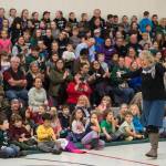 Former teacher Linda Buckley leads Auke Bay Elementary School students in the school song on Friday, Nov. 9, 2018. (Michael Penn | Juneau Empire)