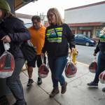 Cassandra Strahin, center, and Nicole Huntsman, both of Allen Marine, get help from Malou Peabody, left, and Clarence Milton as they deliver 30 frozen turkeys to the Glory Hole on Monday, Nov. 6, 2017. (Michael Penn | Juneau Empire)