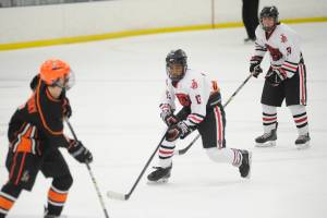 Juneau-Douglas High School senior Finn Yerkes applies pressure on a West Anchorage player on Saturday at the fourth annual Palmer Showdown Tournament at the MTA Events Center in Palmer. (Nolin Ainsworth | Juneau Empire)