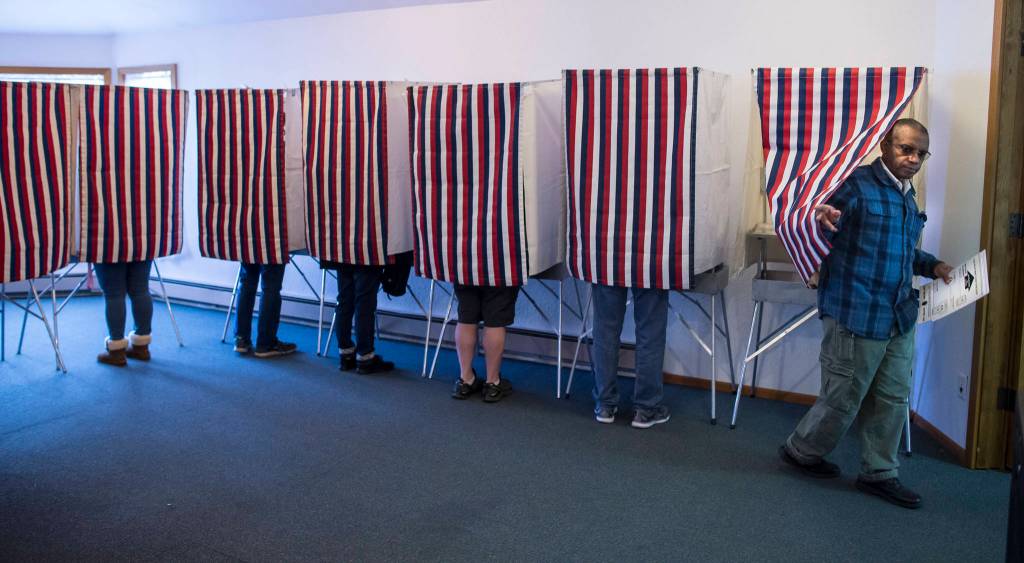 Hector Mojica exits a voting booth at Glacier Valley Baptist Church on Election Day, Tuesday, Nov. 6, 2018. (Michael Penn | Juneau Empire)