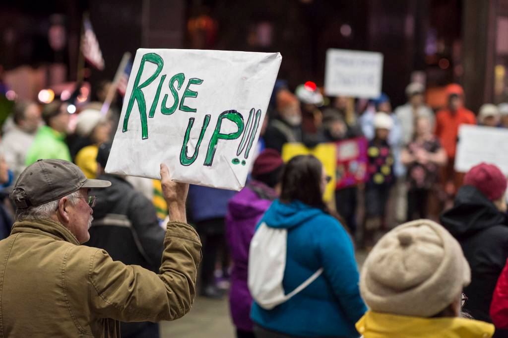 Nearly 100 people show up to protest President Donald Trumps appointment of Matthew Whitaker for U.S. Attorney General outside the Federal Building on Thursday. Many protesters believe Whitakers hiring could jeopardize the Mueller investigation into possible connections between Trumps presidential campaign and the Russian government. (Michael Penn | Juneau Empire)