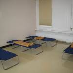 Cots and a blanket wait for homeless people at a new warming shelter in the old Public Safety Building on Whittier Street on Friday, Dec. 1, 2017. (Michael Penn | Juneau Empire File)