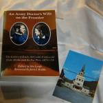 Book of letters about life in post-Russia Sitka by an Army doctors wife, and post card of the original St. Michaels Cathedral before it burned. (Courtesy Photo | Tara Neilson)