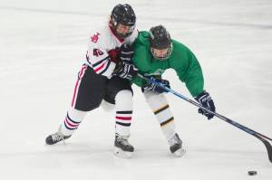 Juneau-Douglas High School junior Ethan Welch checks a Colony player last Thursday during the Palmer Showdown Tournament at the MTA Events Center in Palmer. Welch will face his former team, Palmer, this weekend in two games at Treadwell Arena. (Nolin Ainsworth | Juneau Empire)