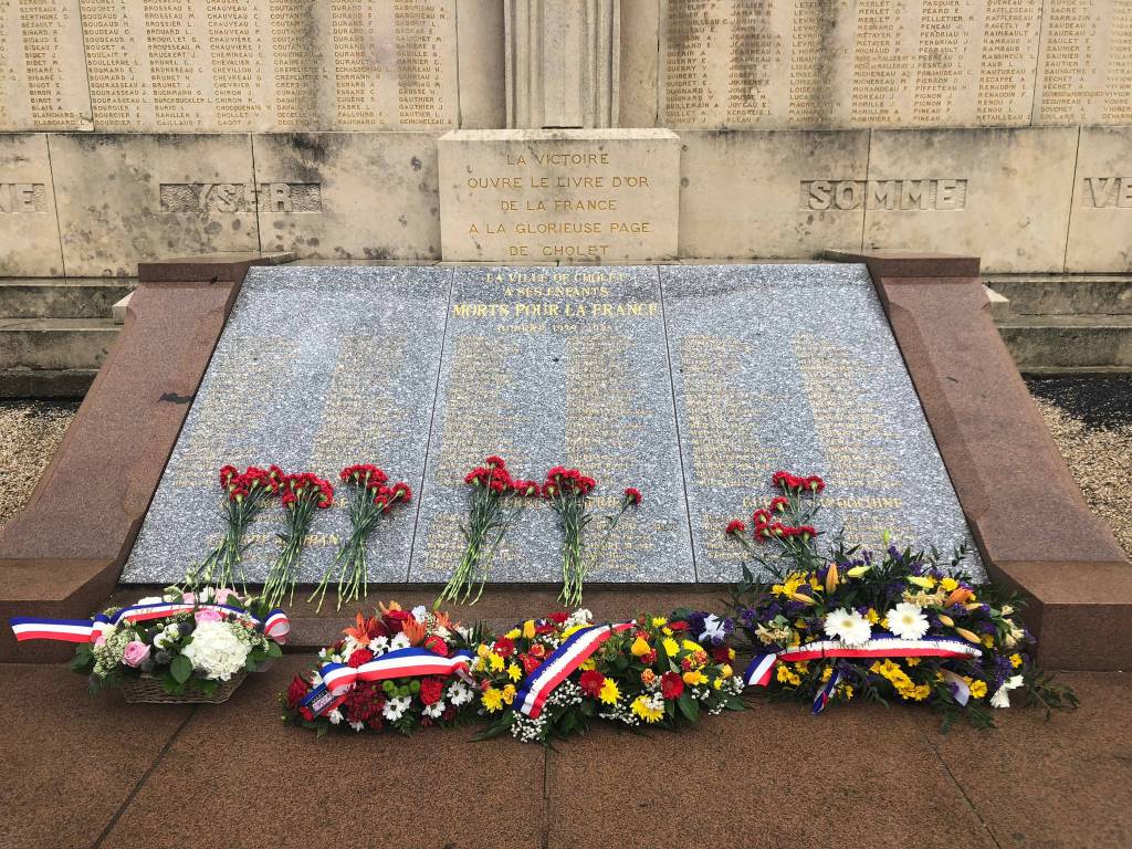 Flowers placed on the Monument aux Morts in front of the Gare de Cholet. (Bridget McTague | For the Juneau Empire)