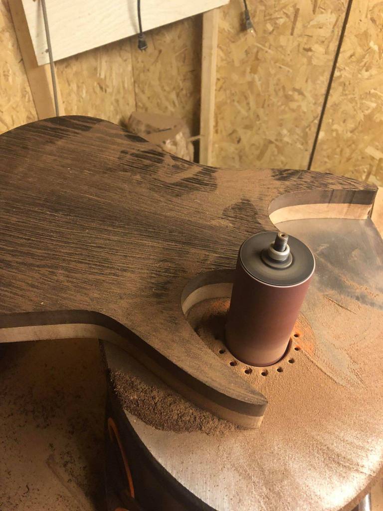 Former Juneauite Tevyn Days, who sings and plays guitar in the metal band Distance Defined, shows the body of the electric guitar he is making. (Courtesy photo | Trevyn Days)