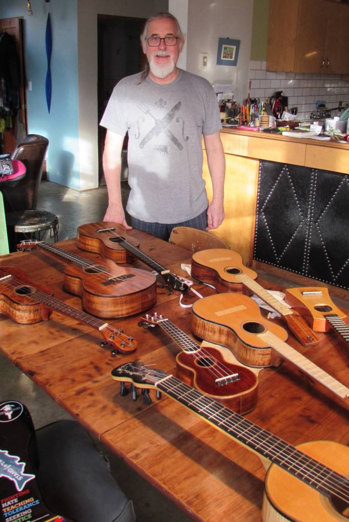 Paul Gardinier displays his handmade ukuleles and guitars on Friday, Nov. 16, 2018. The collection excludes the many instruments he has given as gifts.(Ben Hohenstatt | Capital City Weekly)