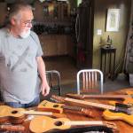 Paul Gardinier looks at a fleet of stringed instruments hes made over the better part of the past decade at his home in Juneau on Nov. 16, 2018.(Ben Hohenstatt | Capital City Weekly)