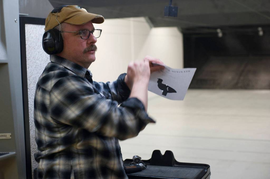 Sven Pearson takes down his target during the Thanksgiving Turkey Shoot at the Alaska Department of Fish and Game Hunter Education Facility rifle range on Saturday. The event was put on by the Juneau Gun Club, Juneau Shooting Sports Foundation, Juneau Archery Club and ADFG and awarded approximately 90 turkeys. (Nolin Ainsworth | Juneau Empire)