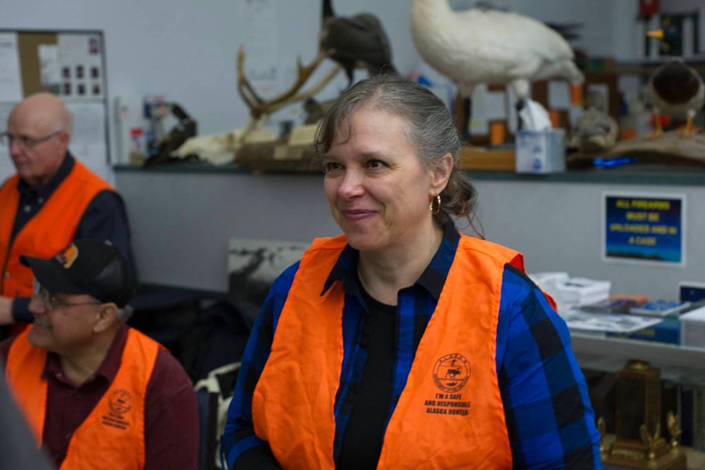 Lori Tupou works the ticket counter for Thanksgiving Turkey Shoot at the Alaska Department of Fish and Game Hunter Education Facility on Saturday. (Nolin Ainsworth | Juneau Empire)