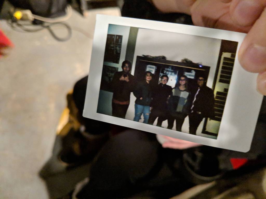 Haley Shervey brought a Polaroid camera to the screening of :Our Alaskan Stories. The photo of filmmakers Michael Martin Jr. Andrea Cook, Shervey, Alyssa Afcan and writer Gina Cole taken by Martins girlfriend, Annie Masterman turned out dark but captured the members of the touring Tidelines residency together. The program is offered through the Island Institute of Sitka. (Ben Hohenstatt | Capital City Weekly)