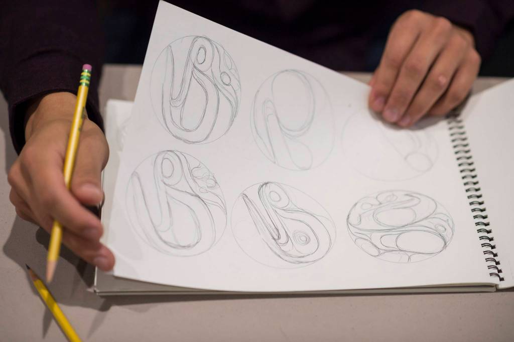 Robert Mills shows examples of formline at the Celebrating Our Ways of Life for Native American Heritage Month at the Elizabeth Peratrovich Hall on Friday, Nov. 16, 2018. (Michael Penn | Juneau Empire)