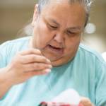 Cecelia Friberg-Rodriguez works on beading a pendant during the Celebrating Our Ways of Life for Native American Heritage Month at the Elizabeth Peratrovich Hall on Friday, Nov. 16, 2018. (Michael Penn | Juneau Empire)