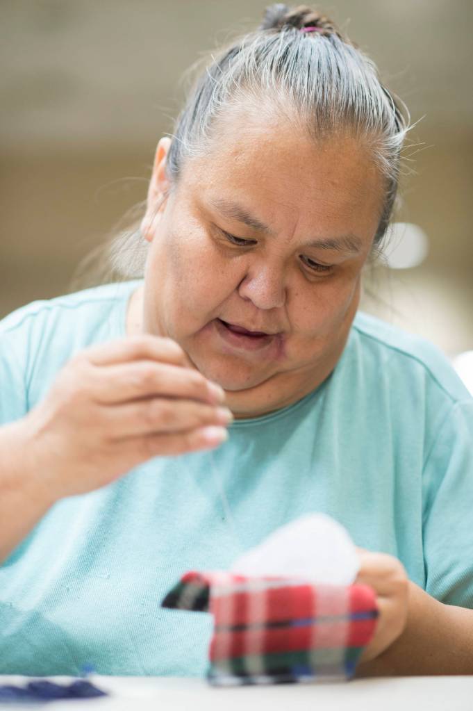Cecelia Friberg-Rodriguez works on beading a pendant during the Celebrating Our Ways of Life for Native American Heritage Month at the Elizabeth Peratrovich Hall on Friday, Nov. 16, 2018. (Michael Penn | Juneau Empire)