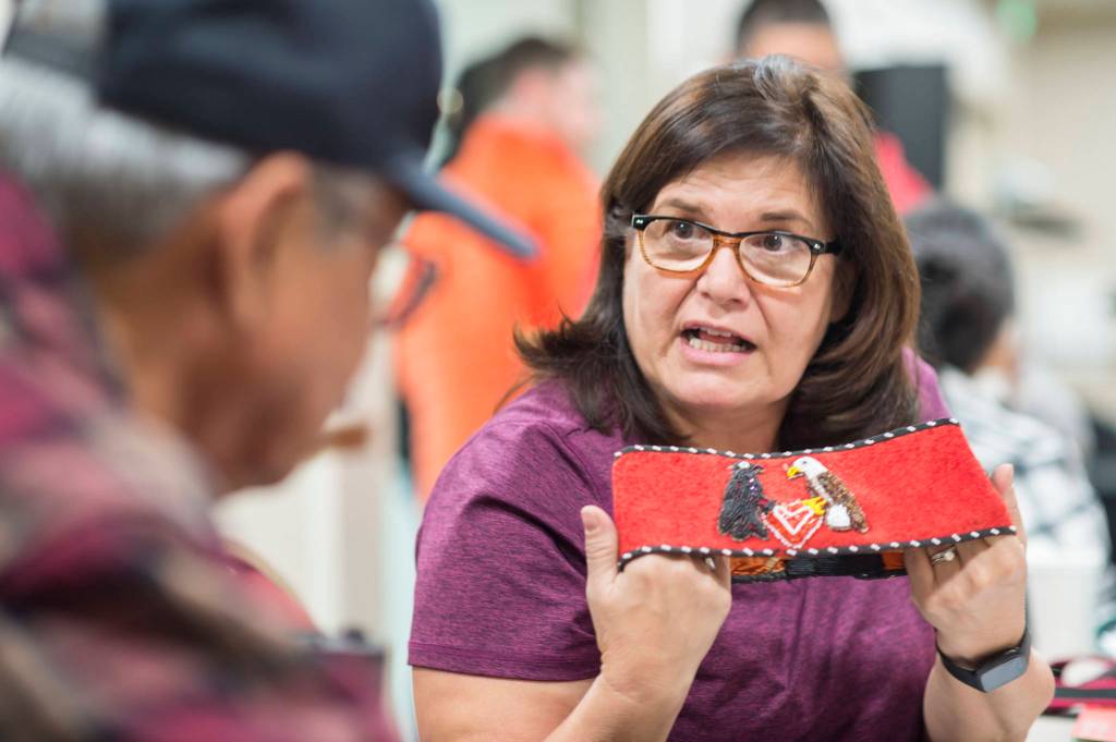 Jackie Pata displays her grandmothers headband while talking about regalia patterns at the Celebrating Our Ways of Life for Native American Heritage Month at the Elizabeth Peratrovich Hall on Friday, Nov. 16, 2018. (Michael Penn | Juneau Empire)