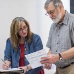 Lauri Wilson, Region 1 Election Supervisor, and Regional Accu-Vote board member David Clover look over a questioned ballot from a Southeast district that failed to run through an Accu-Vote machine at the State of Alaska Election Office in the Mendenhall Mall Annex on Tuesday, Nov. 13, 2018. (Michael Penn | Juneau Empire)