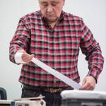 Regional Accu-Vote board member Mel Personett looks at a tally of questioned ballots from a Southeast district at the State of Alaska Election Office in the Mendenhall Mall Annex on Tuesday, Nov. 13, 2018. (Michael Penn | Juneau Empire)