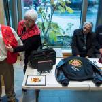 Janet Burke talks about some of her fathers things on display at the Walter Soboleff Center as her brothers, Walter Jr., center, and Sasha, watch on Wednesday, Nov. 14, 2018. Nov. 14 was named Dr. Walter Soboleff Day by the Alaska Legislature in 2014. (Michael Penn | Juneau Empire)