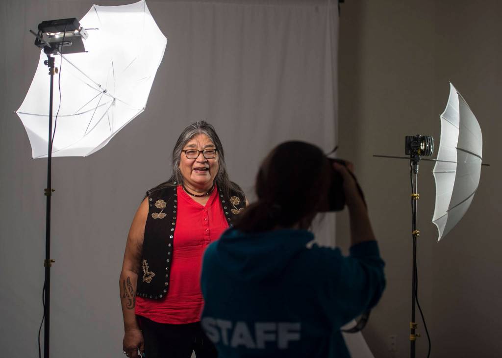 Georgina Sydney, of Teslin, Yukon, has her picture taken by Sealaska Heritage Institutes Nobu Koch at the Voices of Our Ancestors Language Summit at Centennial Hall on Wednesday, Nov. 14, 2018. (Michael Penn | Juneau Empire)