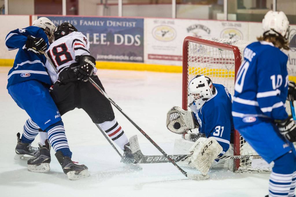 Palmers goalie Tiernan ORourke blocks a point blank shot by Juneau-Douglas Dalton Hoy on Friday, Nov. 16, 2018. (Michael Penn | Juneau Empire