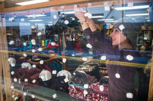 Courtney Manger, co-owner of the Foggy Mountain Shop, uses marshmallows as snowflakes as she decorates her Franklin Street store for Black Friday sales on Wednesday, Nov. 21, 2018. (Michael Penn | Juneau Empire)