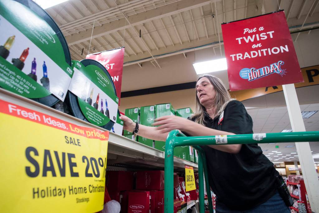 Fred Meyer employee Sandy Demmert stocks season items to be ready for Black Friday sales on Wednesday, Nov. 21, 2018. (Michael Penn | Juneau Empire)
